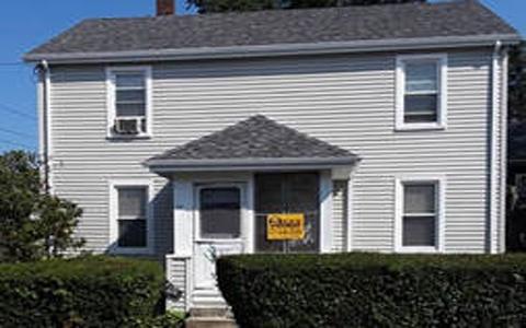 Roofing crew installing shingles on a multi-family home