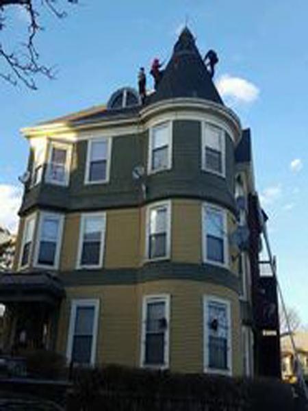 Roofing crew working on a Victorian home in Greater Boston